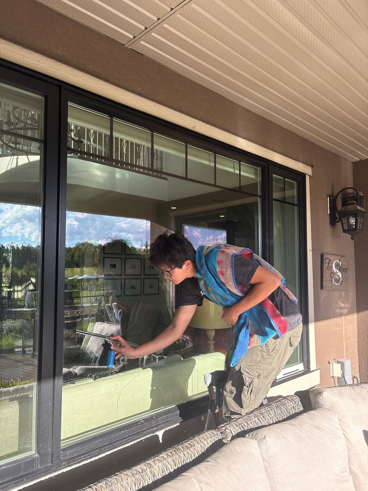 Squeegee window cleaning on a Calgary stone home