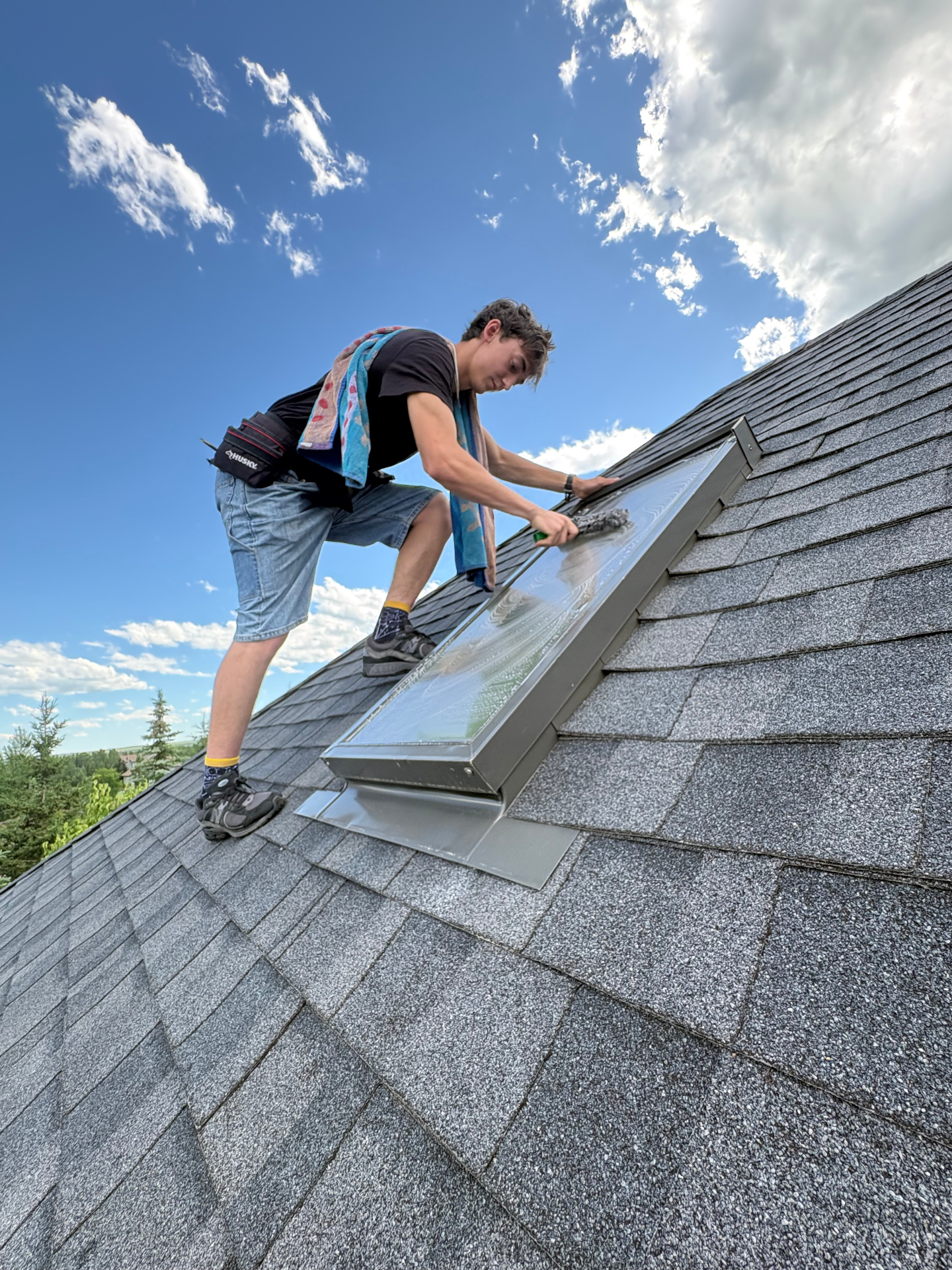 Skylight cleaning on a residential roof in Calgary
